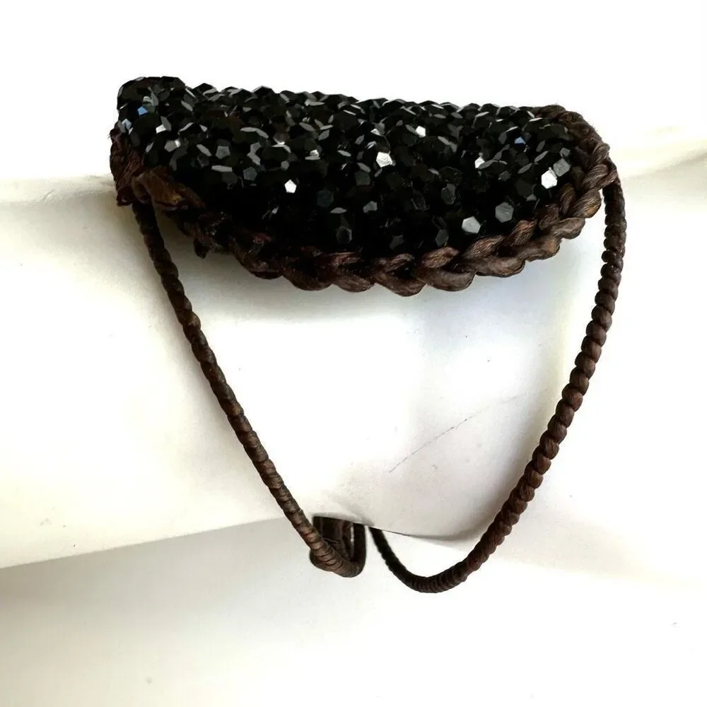 Round  black beaded bracelet on brown cord